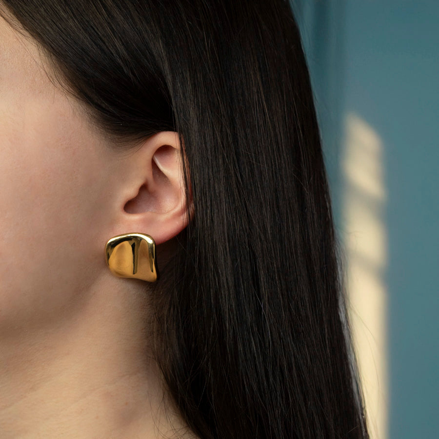 Gouden oorbellen minimalistisch, elegant en tijdloos. Oorbellen gedragen dor model.